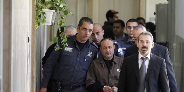 An Israeli prison guard (L) escorts jailed Fatah leader Marwan Barghouti (C) to a deliberation at Jerusalem Magistrate's court January 25, 2012. Convicted of murder for his role in attacks on Israelis, Barghouti was jailed for life by Israel in 2004.
REUTERS/Baz Ratner (JERUSALEM - Tags: POLITICS CRIME LAW)