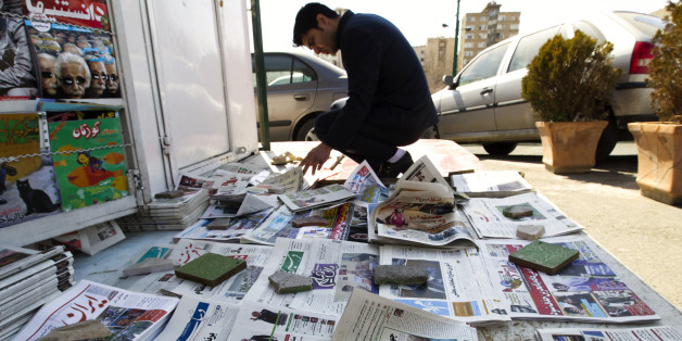 EDITORS' NOTE: Reuters and other foreign media are subject to Iranian restrictions on leaving the office to report, film or take pictures in Tehran.
A man looks at newspapers at a news stand in Tehran March 4, 2012. Hardliners allied with Iran's Supreme Leader Ayatollah Ali Khamenei maintained their lead in the country's parliamentary vote, with partial results on Sunday showing supporters of the president trailing behind. REUTERS/Raheb Homavandi (IRAN - Tags: POLITICS ELECTIONS)