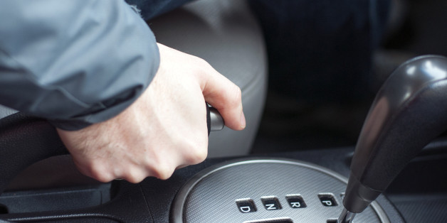 driver pulling the hand brake in car