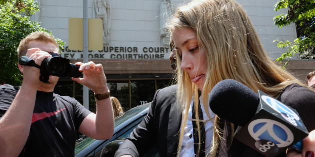 Actress Amber Heard leaves Los Angeles Superior Court court on Friday, May 27, 2016, after giving a sworn declaration that her husband Johnny Depp threw her cellphone at her during a fight Saturday, striking her cheek and eye. The judge ordered Depp to stay away from his estranged wife and ruled that Depp shouldn't try to contact Heard until a hearing is conducted on June 17. Heard filed for divorce on Monday. (AP Photo/Richard Vogel)