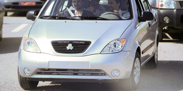 EDITORS' NOTE: Reuters and other foreign media are subject to Iranian restrictions on leaving the office to report, film or take pictures in Tehran. Iran's President Mahmoud Ahmadinejad (R) drives an Iranian-made car called Tiba, during the opening ceremony of the Iranian Saipa automaker factory in Kashan, 258 km (161 miles) south of Tehran, May 9, 2010. REUTERS/Fars News/Mehdi Marizad (IRAN - Tags: TRANSPORT POLITICS BUSINESS) QUALITY FROM SOURCE
