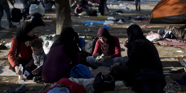 Migrants rest at a park in Belgrade, Serbia, Thursday, Aug. 27, 2015. Over 10,000 migrants, including many women with babies and small children, have crossed into Serbia over the past few days and headed toward Hungary and the EU Schengen Area, a zone with no internal border checks between member countries. (AP Photo/Marko Drobnjakovic)