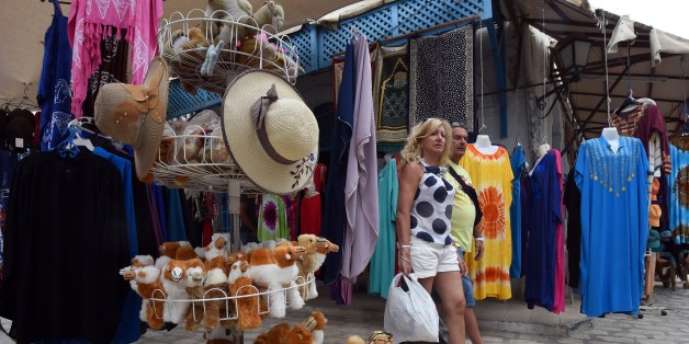 Tourists walk throught the streets in the souk of Djerba on the Tunisian island on May 17, 2014. Pilgrims arrived at Tunisia's Ghriba synagogue, the oldest in Africa, expressing hope that this year would mark a turning point for the ritual despite a rise in Islamist unrest since the 2011 revolution. AFP PHOTO / FETHI BELAID (Photo credit should read FETHI BELAID/AFP/Getty Images)