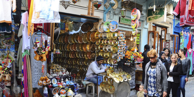 Tunisians walk in a market of Tunis, Friday, March 20, 2015. Yet another terror attack is taking its toll on tourism, with cruise companies cancelling stops in Tunisia following the killings of 21 people. Seventeen of those killed at the Bardo National Museum in Tunis were passengers on shore excursions from two cruise ships in port that day. (AP Photo/Salah Ben Mohamed)