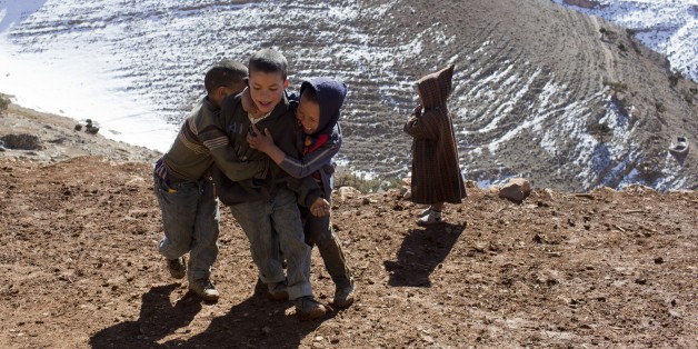 Children play in Ait Sghir village in the High Atlas region of Morocco February 14, 2015. The snowy foothills of the High Atlas mountains in Morocco are home to several Berber villages where the inhabitants make their living by farming, baking bread in traditional ovens, herding cattle, and the making and selling of honey, olive oil and pottery. Extreme weather fluctuations and erosion that causes flooding and landslides have led to a drop in agricultural productivity, the United Nations said.