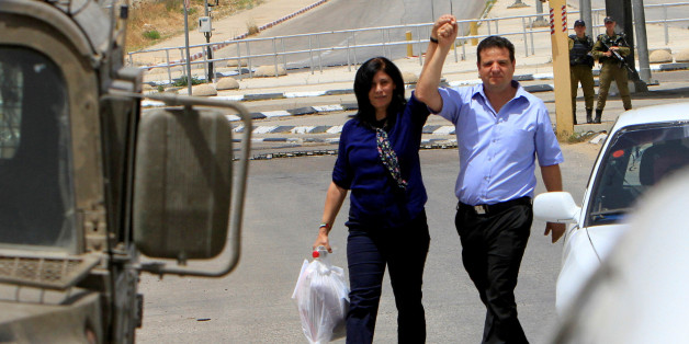 Palestinian lawmaker Khalida Jarrar (L) holds the hand of Arab-Israeli Knesset member Ayman Odeh following her release from an Israeli jail at Israeli Jbara checkpoint near the West Bank city of Tulkarm June 3, 2016. REUTERS/Abed Omar Qusini