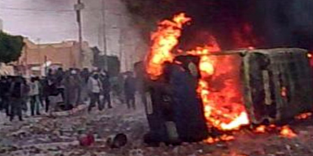 In this frame grab image taken from amateur video and acquired by APTN protesters are seen amid a burning vehicle in Douz, Tunisia, Wednesday Jan. 12, 2011. A witness in the central city of Douz said there were two deaths at a protest there Wednesday. Tear gas and stone-throwing youths reached the heart of Tunisia's once-calm capital Wednesday as rioters desperate for jobs defied their autocratic president in escalating unrest that poses his biggest challenge in 23 years in power. (AP Photo)