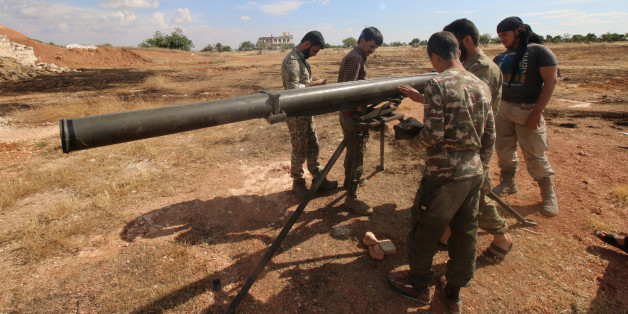 Rebel fighters from the First Regiment, part of the Free Syrian Army, prepare to fire a Grad rocket from Aleppo's Al-Haidariya neighbourhood, towards forces loyal to Syria's President Bashar al-Assad stationed in Talet al-Sheikh Youssef, Syria May 29, 2016. REUTERS/Abdalrhman Ismail