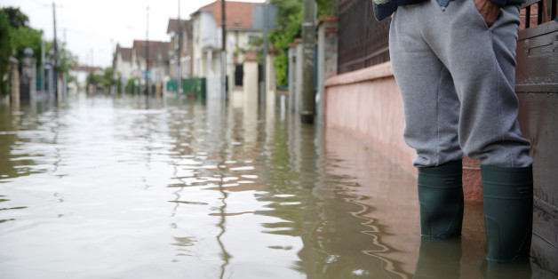 A resident stands in front of his house in a flooded suburb of Villeneuve Saint-Georges, outside Paris, June 3, 2016. REUTERS/Christian Hartmann