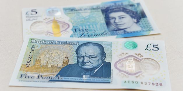 The new £5 (6.5 euros, $7.2) banknote bearing the image of wartime leader Winston Churchill is on show at its unveiling by the Bank of England at Blenheim Palace in Woodstock on June 2, 2016.
The note, to be rolled out from September, is the first to be printed on polymer -- a thin, flexible plastic film that is seen as more durable and secure and is already used in Australia and Canada. / AFP / POOL / Joe Giddens (Photo credit should read JOE GIDDENS/AFP/Getty Images)