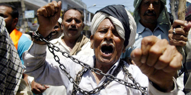 West Pakistani refugees shout slogans against the Indian government protesting discrimination in Jammu, India, Wednesday, Aug. 15, 2007. The West Pakistani Refugee Action Committee has decided to observe Indian Independence Day as "Black Day" for their community, as their community is still allegedly living the life of the slaves in independent India. (AP Photo/Channi Anand)