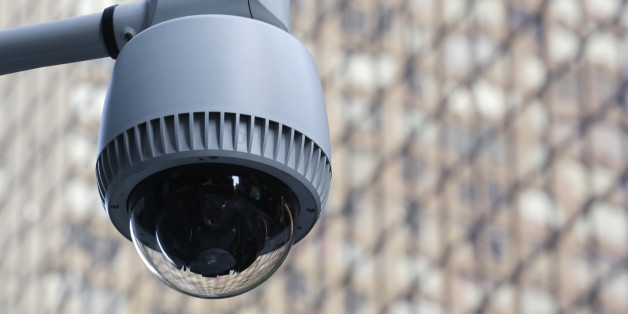 A security camera, center, is mounted on the side of a building overlooking an intersection in midtown Manhattan, Wednesday, July 31, 2013 in New York. (AP Photo/Mark Lennihan)