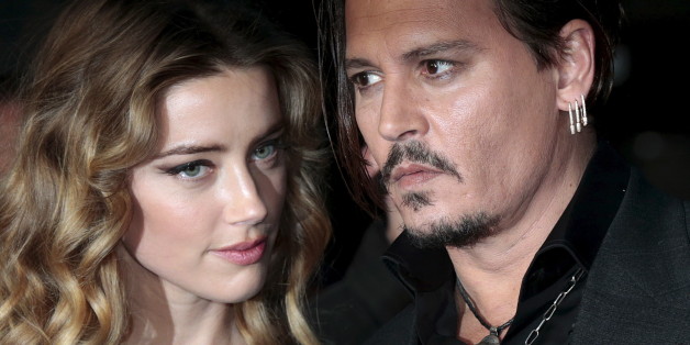 Cast member Johnny Depp and his actress wife Amber Heard arrive for the British premiere of the film "Black Mass" in London, Britain October 11, 2015. REUTERS/Suzanne Plunkett