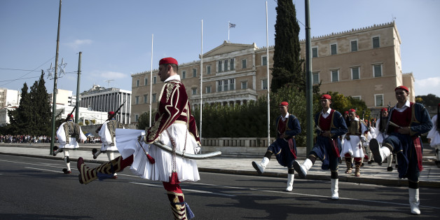 Presidential guards perform ceremonial duties in front of the parliament in Athens, Sunday, Nov. 15, 2015. Greece's government is currently locked in negotiations to reach an agreement on the disbursement of a 2 billion-euro installment ($2.2 billion), as well as 10 billion euros set aside for the recapitalization of its banks. While Greece has met many of the requirements, it remains at odds with creditors over how to deal with non-performing loans and the repossession of homes whose owners have fallen into arrears on mortgage payments. (AP Photo/Yorgos Karahalis)