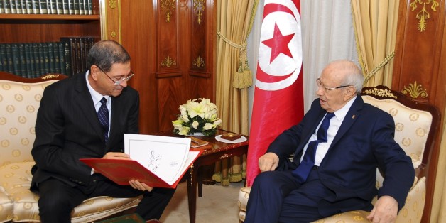 New Tunisian Prime Minister Habib Essid, left, and Tunisian President Beji Caid Essebsi check the list of the cabinet members, Friday, Jan.23, 2015 in Tunis. A month after the last election ending its democratic transition, Tunisia announces the makeup of the new coalition government tasked with seeing the country out of its current economic crisis. (AP Photo/Hassene Dridi)