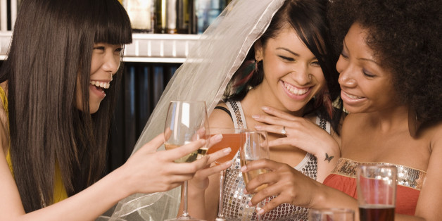 Multi-ethnic friends drinking in nightclub for bachelorette party