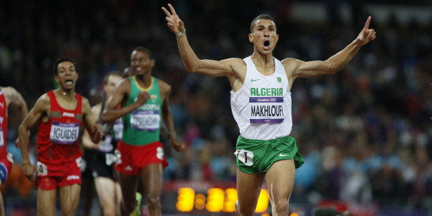 Algeria's Taoufik Makhloufi (front) celebrates as he wins the men's 1500m final during the London 2012 Olympic Games at the Olympic Stadium August 7, 2012. REUTERS/Lucy Nicholson (BRITAIN - Tags: SPORT ATHLETICS OLYMPICS)