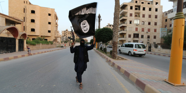 A member loyal to the Islamic State in Iraq and the Levant (ISIL) waves an ISIL flag in Raqqa June 29, 2014. The offshoot of al Qaeda which has captured swathes of territory in Iraq and Syria has declared itself an Islamic "Caliphate" and called on factions worldwide to pledge their allegiance, a statement posted on jihadist websites said on Sunday. The group, previously known as the Islamic State in Iraq and the Levant (ISIL), also known as ISIS, has renamed itself "Islamic State" and proclaimed its leader Abu Bakr al-Baghadi as "Caliph" - the head of the state, the statement said. REUTERS/Stringer (SYRIA - Tags: POLITICS CIVIL UNREST ) BEST QUALITY AVAILABLE