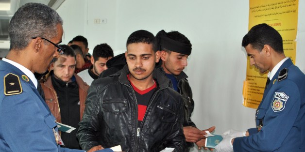 Egyptians, who were formerly residing in Libya, have their documents checked by Tunisian customs at Djerba airport on the Tunisian-Libyan border, before their departure for Cairo, on February 23, 2015. At least 1,000 Egyptians have been evacuated from Libya through Tunisia since February 20, the Tunisian transport ministry said, following the murder of Coptic Christians by the Islamic State group. AFP PHOTO / FETHI NASRI (Photo credit should read FETHI NASRI/AFP/Getty Images)