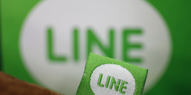The logo of free messaging app Line is pictured on a smartphone and the company's stuffed toy in this photo illustration taken in Tokyo September 23, 2014. Naver Corp held off on an IPO for its Line Corp unit on the belief that the messaging app operator can command a better valuation by further building its revenue and profit, Naver's chief financial officer told Reuters on Tuesday. South Korea-based Naver said on Monday that it does not plan an initial public offering for Line this year, dashi