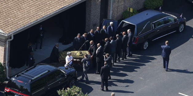 The casket bearing the remains of Muhammad Ali is loaded into a hearse at the A D Porter & Sons funeral home during the funeral procession for the three-time heavyweight boxing champion in Louisville, Kentucky, U.S., June 10, 2016. REUTERS/Adrees Latif