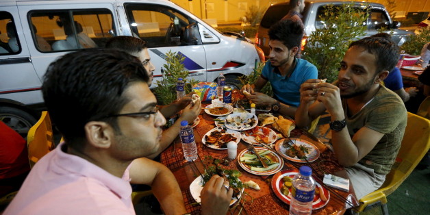 Iraqi youths eat the pre-dawn Suhoor meal before the start of the daily Ramadan fast in a restaurant in Baghdad, July 8, 2015. The lifting of a night-time curfew in the Iraqi capital five months ago means that, for the first time since the 2003 U.S.-led invasion brought violence and turmoil, lavish Ramadan meals can stretch on until dawn. While the rest of the country fragments, hardline Islamic State fighters battle the army less than 50 km (30 miles) away, and car bombs still regularly inflict their deadly toll across the city, people seize gratefully at any chance to enjoy life. Picture Taken July 8, 2015. To match story MIDEAST-CRISIS/BAGHDAD REUTERS/Thaier Al-Sudani