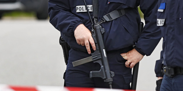 Police man a roadblock at the scene where a French police commander was stabbed to death in front of his home in the Paris suburb of Magnanville, France, June 14, 2016. REUTERS/Christian Hartmann