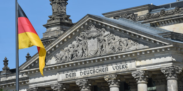 A German national flag is displayed in front of the main entrance of the Reichstag building, seat of the German lower house of parliament Bundestag, on June 7, 2016 in Berlin. / AFP / CHRISTOF STACHE (Photo credit should read CHRISTOF STACHE/AFP/Getty Images)