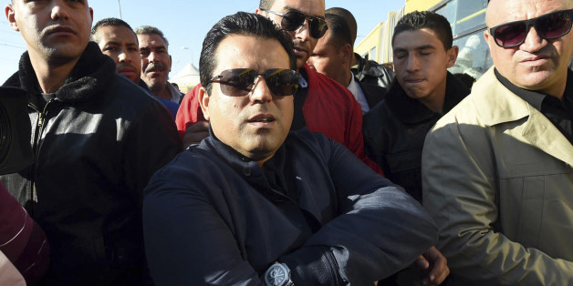 Independent candidate Slim Riahi, center, a Tunisian businessman and politician, campaigns in Tunis, Wednesday, Nov.19, 2014. The presidential campaign, featuring 25 competitors, kicked off in early November and it's the first time since Tunisians overthrew dictator Zine El Abidine Ben Ali in 2011 that they will choose their head of state through universal suffrage. If no candidate wins a majority Nov. 23, there will be a runoff between the top two vote-getters on Dec. 28. (AP Photo)