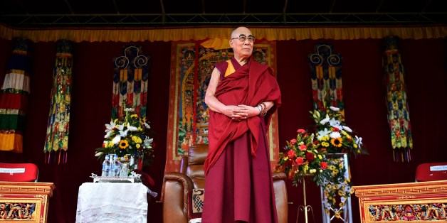 The Dalai Lama takes to the stage to address the faithful in Aldershot on June 29, 2015 which has a large Nepalese Buddhist community made up mainly of serving and retired Gurkha soldiers. AFP PHOTO / BEN STANSALL (Photo credit should read BEN STANSALL,BEN STANSALL/AFP/Getty Images)