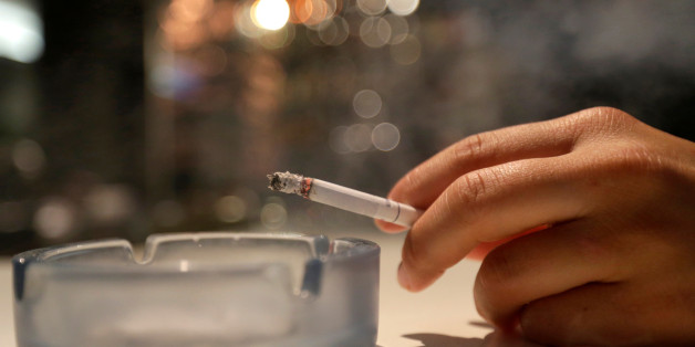 A customer smokes a cigarette in a cafe in Prague, Czech Republic, May 25, 2016. REUTERS/David W Cerny