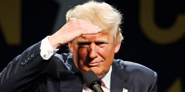 Republican presidential candidate Donald Trump shields his eyes to look out at the audience during a campaign rally in Greensboro, North Carolina June 14, 2016. REUTERS/Jonathan Drake