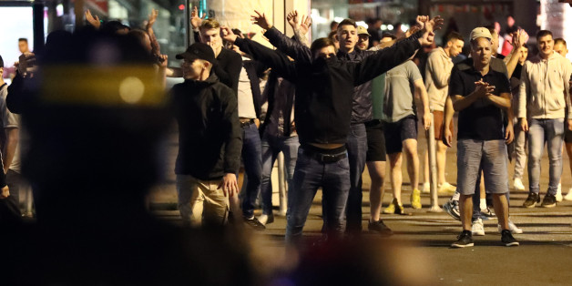 LILLE, FRANCE - JUNE 16: England fans gesture at police officers during clashes aon June 16, 2016 in Lille, France. Police used tear gas and pepper spray on the fans in a bid to keep public order in the city centre this evening. (Photo by Carl Court/Getty Images)