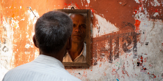 KOLKATA, WEST BENGAL, INDIA, CALCUTTA, WEST BENGAL, INDIA - 2011/10/31: Man looking at the mirror in a street barbershop in Kolkata (Calcutta). West Bengal, India. (Photo by Marji Lang/LightRocket via Getty Images)