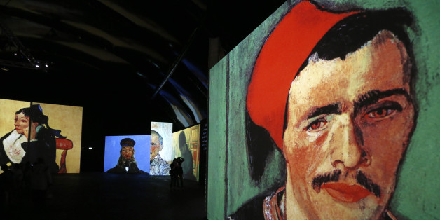 People visit the Van Gogh Alive exhibition in St. Petersburg, September 11, 2014. More than 3,000 images associated with the life and work of Van Gogh are on display during the exhibition. REUTERS/Alexander Demianchuk (RUSSIA - Tags: ENTERTAINMENT SOCIETY)