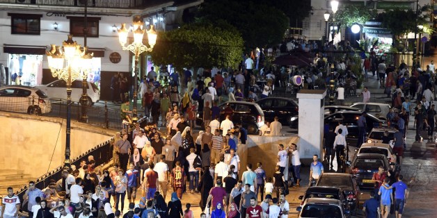 TO WITH AFP STORY BY AMER OUALI Algerians gather outside Algiers' Grand Post Office during the Muslim holy fasting month of Ramadan on July 12, 2015. During Ramadan the Algerian capital comes alive with animation largely subsidized by the government to prevent the young from becoming strongly influenced by the Imams in this pious period. AFP PHOTO / FAROUK BATICHE (Photo credit should read FAROUK BATICHE/AFP/Getty Images)