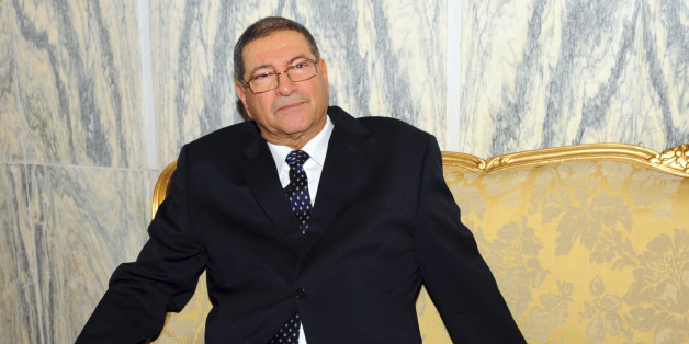Habib Essid, 65, sits in a sofa before being asked by the newly elected president to form a coalition and name a Cabinet over the next month, Monday, Jan.5, 2015 in Tunis. Tunisia's largest political party chose a veteran from the country's former dictatorship as its candidate for prime minister Monday and he began work immediately on forming a coalition government. (AP Photo/Hassene Dridi)