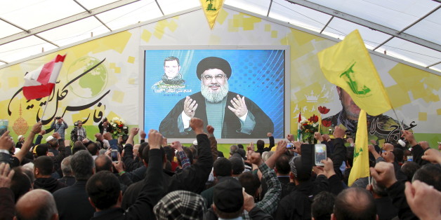 Lebanon's Hezbollah leader Sayyed Hassan Nasrallah addresses his supporters via a screen during a commemoration service marking one week since the death of Ali Fayyad, one of Hezbollah's senior commanders killed fighting alongside Syrian army forces in Syria, in Ansar village, southern Lebanon March 6, 2016. REUTERS/Aziz Taher