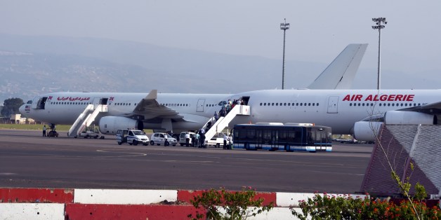 Passengers board an Air Algerie plane at the Houari-Boumediene International Airport in Algiers on July 24, 2014. An Air Algerie plane missing since early July 24 over Mali with 116 passengers and crew, including 50 French nationals, on board probably crashed, French Foreign Minister Laurent Fabius said. AFP PHOTO/FAROUK BATICHE (Photo credit should read FAROUK BATICHE/AFP/Getty Images)