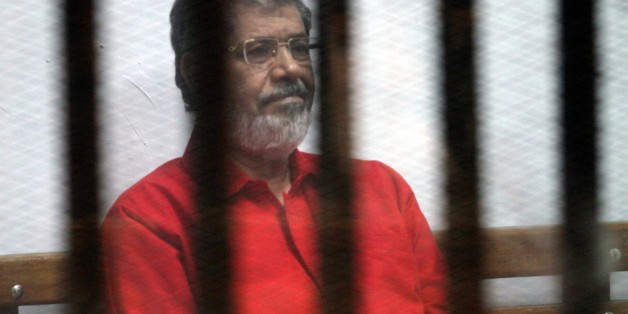 CAIRO, EGYPT - JUNE 18: Egypts ousted President Mohamed Morsi is seen behind the bars during his trial on charges of espionage on behalf of Qatar at the Police Academy in Cairo, Egypt on June 18, 2016. (Photo by Ahmed Gamil/Anadolu Agency/Getty Images)