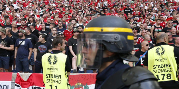 A French riot police officer walks past the Hungarian fans sector prior to the Euro 2016 Group F soccer match between Iceland and Hungary at the Velodrome stadium in Marseille, France, Saturday, June 18, 2016. Hungarian fans have clashed with stewards ahead of their team's game against Iceland at the European Championship. (AP Photo/Ariel Schalit)