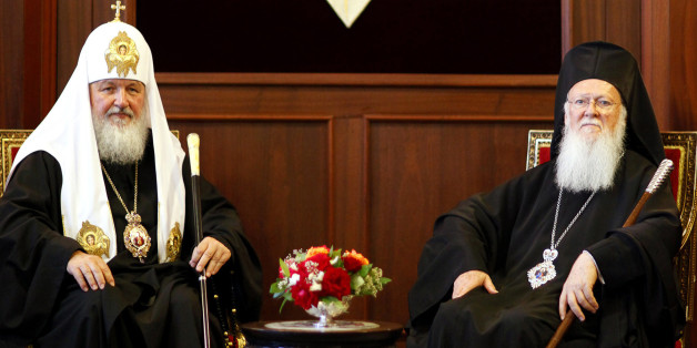 Ecumenical Greek Orthodox Patriarch Bartholomew I (R) and Russian Orthodox Patriarch Kirill pose for media at the Fener Greek Orthodox patriarchate in Istanbul July 4, 2009.The spiritual leader of the world's Orthodox Christians and the head of the Russian Orthodox Church put on a united front on Saturday as they met for talks in Istanbul. REUTERS/Kerim Okten/Pool (TURKEY SOCIETY RELIGION)