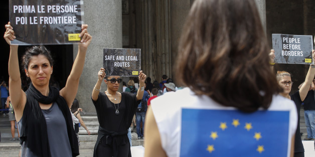 Activists hold placards in various languages reading "People before borders" during a flash mob organized by Amnesty International Italia on the occasion of the 'World Refugee Day'', in front of Rome's Pantheon, Monday, June 20, 2016. The UN Refugee Agency launched its #WithRefugees petition to send a message to governments that they must work together and do their fair share for refugees. (AP Photo/Fabio Frustaci)