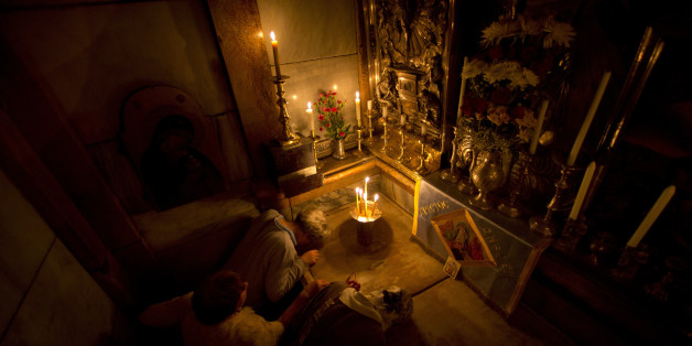 Christians pray jesus' tomb in side as team of experts begin renovation of Jesus' tomb in Jerusalem's Church of the Holy Sepulchre in Jerusalem's old city, Monday, June 6, 2016. A team of experts has begun a historic renovation at the spot where Christians believe Jesus was buried, overcoming longstanding religious rivalries to carry out the first repairs at the site in over 200 years. (AP Photo/Ariel Schalit)