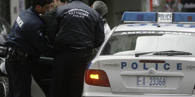 Greek police detain a man for questioning in central Athens, Greece, near the scene of a gunfire and a hand grenade attack that severely injured a riot police officer early Monday, Jan. 5, 2009. Authorities say one of the weapons used by gunmen was the same one used against a police station last year in an attack claimed by a domestic extremist group that has previously targeted the U.S. Embassy. Monday's attack marks a sudden escalation of violence that erupted after the fatal police shooting of a teenager last month. Alexandros Grigoropoulos' death on Dec. 6 sparked Greece's worst riots in decades, with masked protesters frequently attacking police with gasoline bombs and rocks. (AP Photo/Petros Giannakouris)
