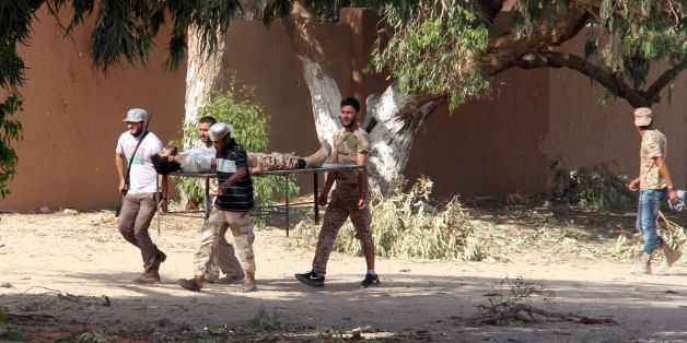 Forces loyal to Libya's UN-backed unity government carry a comrade wounded during clashes with jihadists in the city of Sirte, 450 kilometres (280 miles) east of Tripoli, as they take part in an operation to recapture the city from the Islamic State (IS) group, on June 12, 2016.Forces allied with Libya's unity government, who entered Sirte on June 8 and have been advancing more quickly than expected against IS, which seized control of the coastal city last year and turned it into its main base o