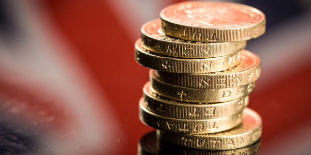 A stack of British one pound sterling coins stand in front of British Union flag, also known as a Union Jack, in this arranged photograph in Guildford, U.K., on Monday, June 13, 2016. Sterling swung on Monday as anxiety about Britains referendum on staying or leaving the European Union continued to build. Photographer: Jason Alden/Bloomberg via Getty Images