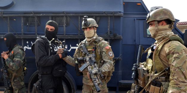 Tunisian special forces stand outside a house containing the body of a man after security forces said they killed a 'terrorist' on March 21, 2016 on the outskirts the southern border town of Ben Guerdane where jihadists mounted a deadly assault earlier this month.
The security source said the raid came as part of an operation launched on March 20, 2016 to target the alleged killer of an official in the security forces during the March 7 assault. The army and security forces have deployed around Ben Guerdane since jihadists launched a dawn assault on security installations in the area on March 7, killing 13 members of the security forces and seven civilians.
/ AFP / FATHI NASRI (Photo credit should read FATHI NASRI/AFP/Getty Images)