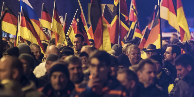 People hold flags in Erfurt, central Germany, Wednesday, March 16, 2016, during a demonstration initiated by the Alternative for Germany (AfD) party against the immigration situation. (AP Photo/Jens Meyer)