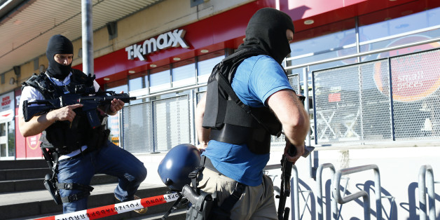 German special police walks past a cinema complex after a masked man with a gun and ammunition belt opened fire in the small western town of Viernheim, near Frankfurt, Germany, June 23, 2016. REUTERS/Ralph Orlowski